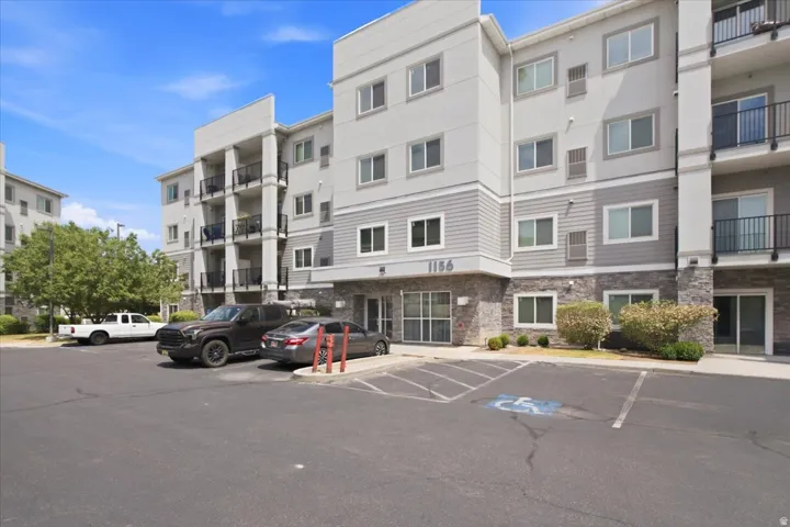 Contemporary multi-story building featuring a facade with mixed siding, stone veneer, and stucco finishes