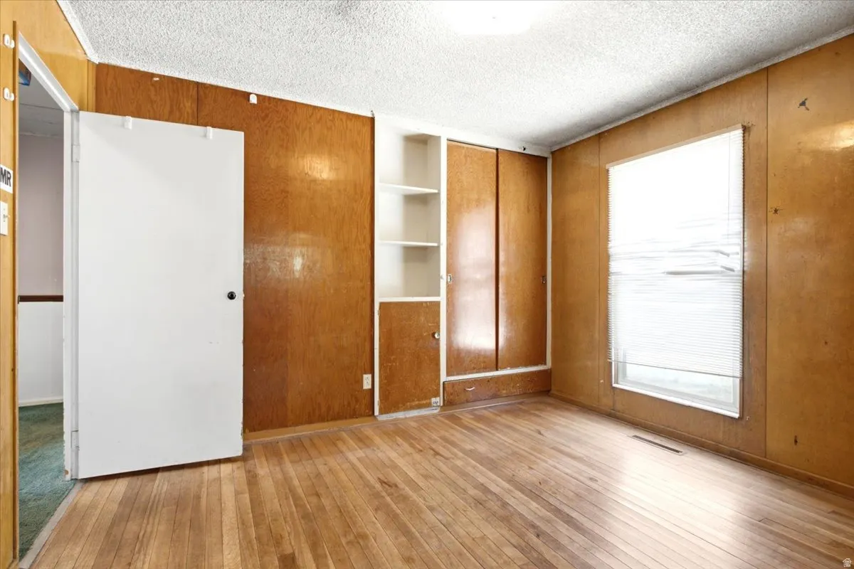 Interior room featuring wood-finish flooring and wood paneling