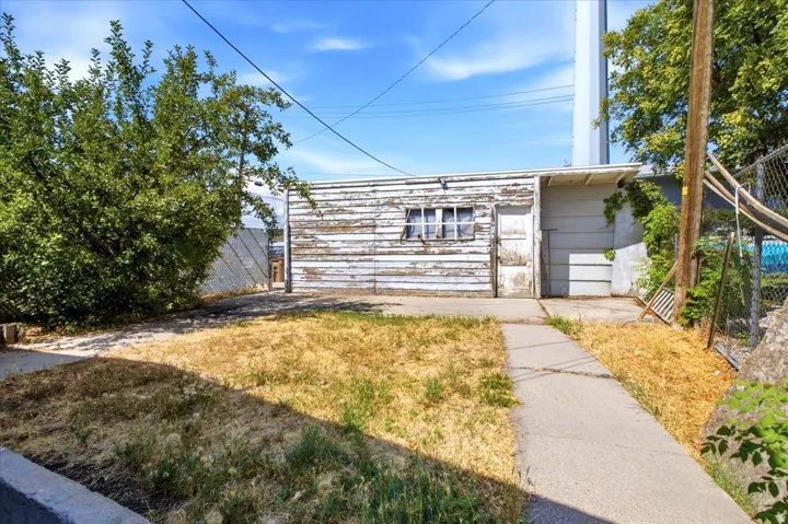 Detached garage structure featuring horizontal siding and multiple access points