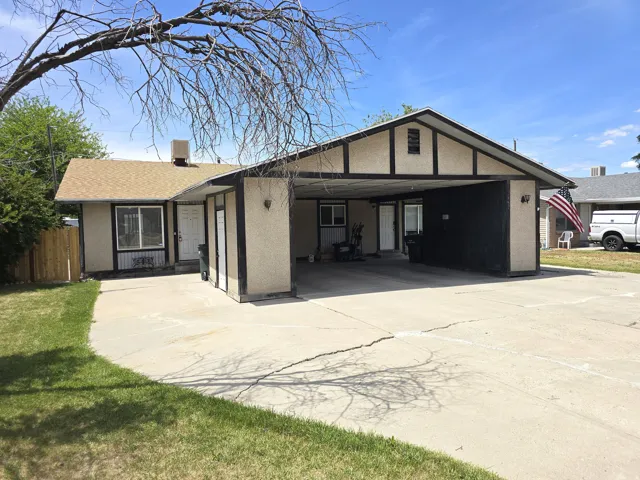 Ranch-style exterior with a covered carport and gabled roof