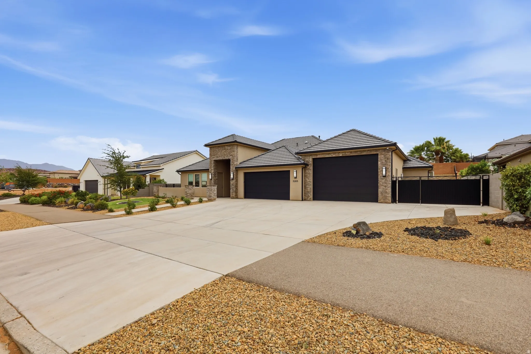Contemporary exterior with stone accents and a tile roof