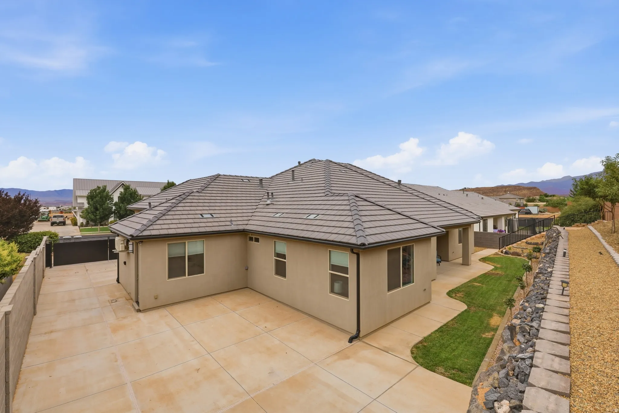 Contemporary stucco exterior with a multi-pitch tile roof