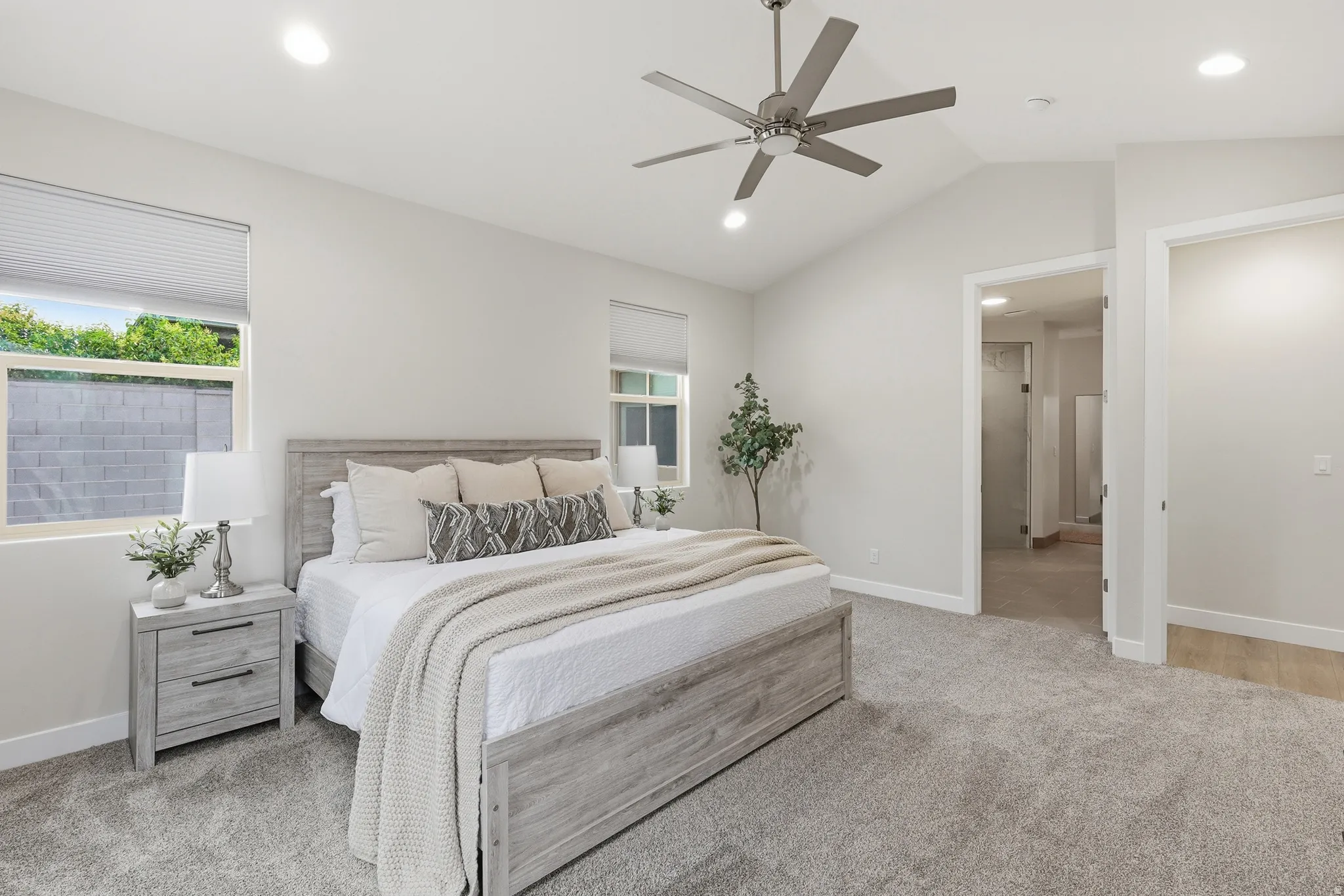 Vaulted ceiling bedroom featuring plush carpeting, recessed lighting, and a contemporary ceiling fan