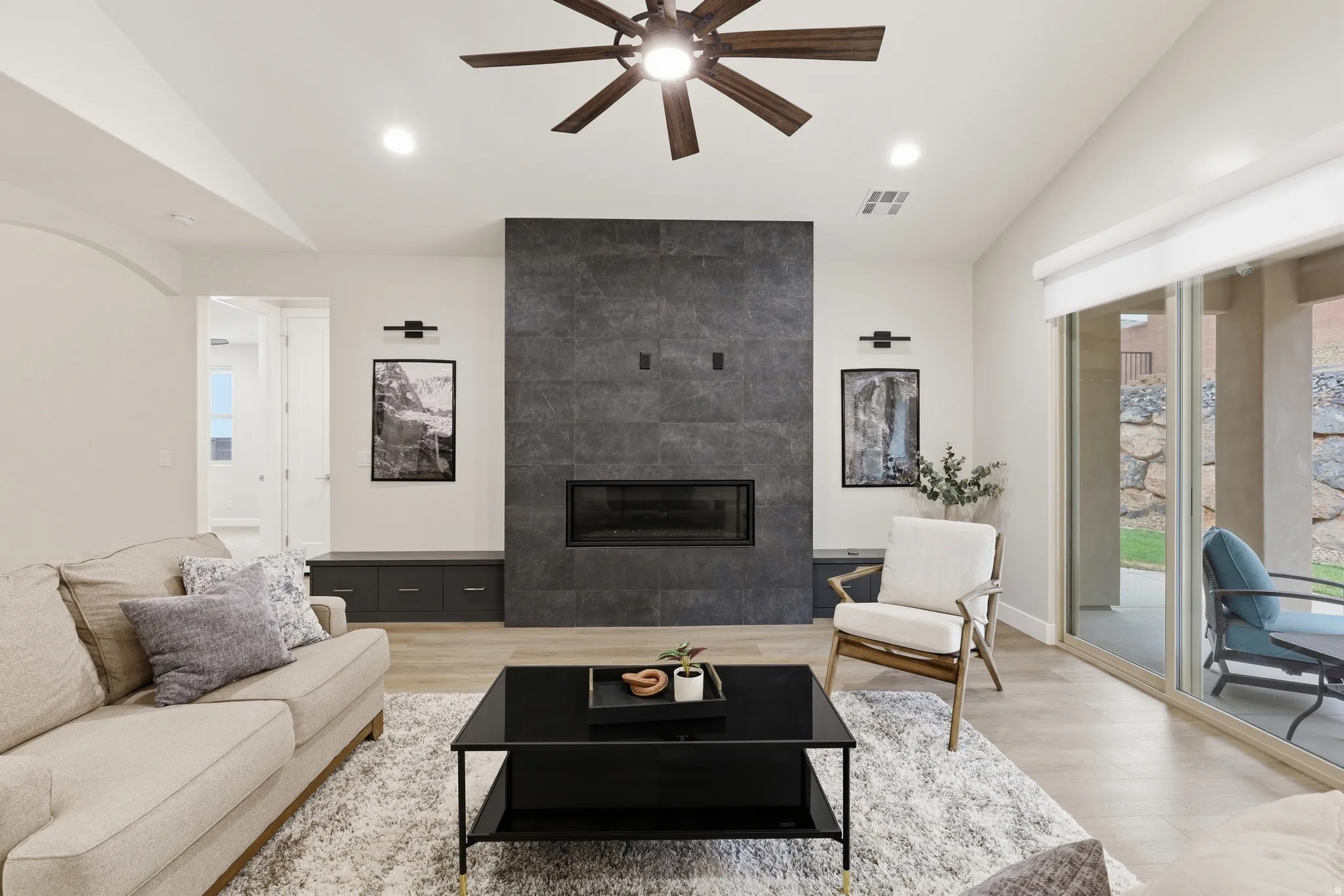 Living area featuring a floor-to-ceiling dark tile fireplace surround with an integrated firebox