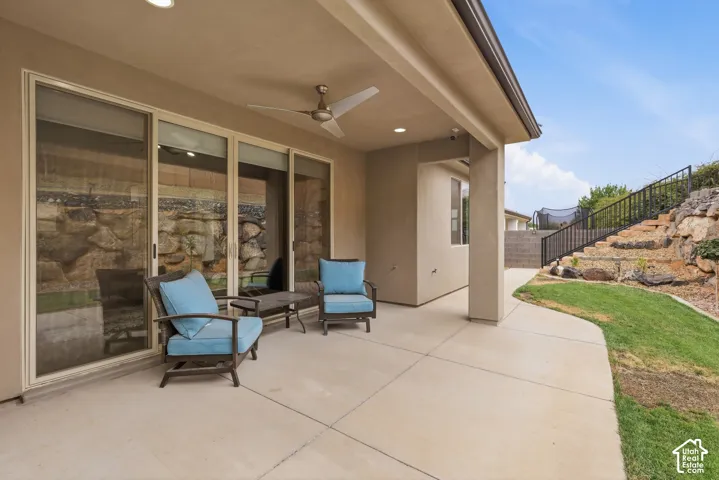 Paved patio with an overhead ceiling fan, recessed lighting, and large sliding glass doors