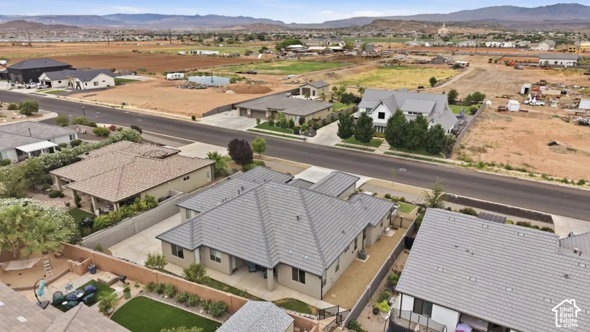 Contemporary residential property featuring a gray tile roof and a fenced perimeter