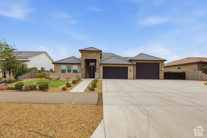 Contemporary stucco and stone-clad exterior with a tiled roof