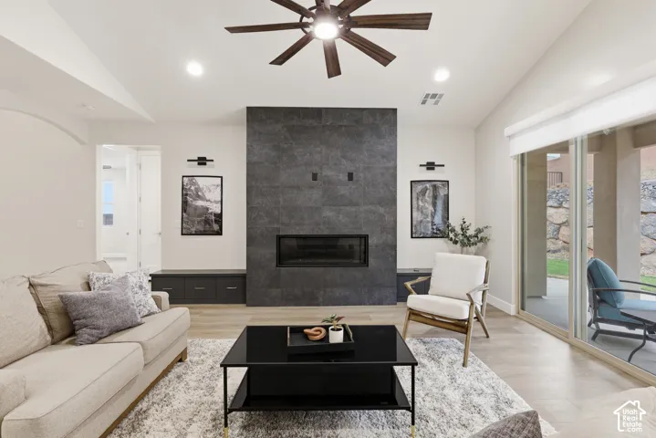 Living area featuring a floor-to-ceiling dark tile fireplace surround with an integrated firebox