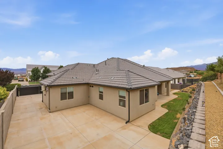 Contemporary stucco exterior with a multi-pitch tile roof
