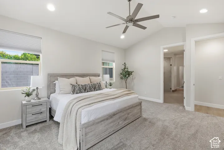 Vaulted ceiling bedroom featuring plush carpeting, recessed lighting, and a contemporary ceiling fan