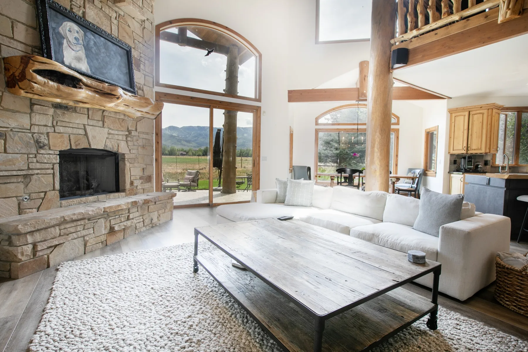 Stone-faced fireplace with a natural wood mantel