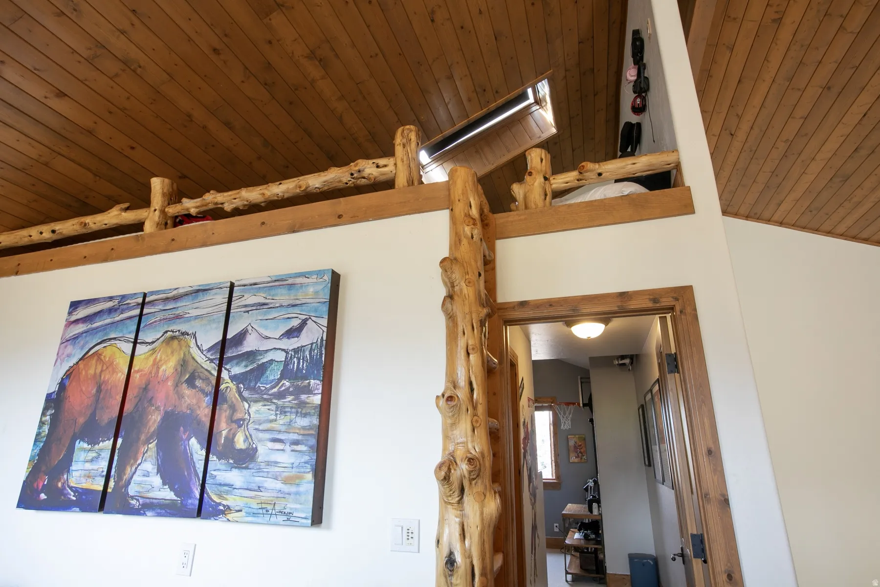Angled wood-finish plank ceilings with a visible skylight