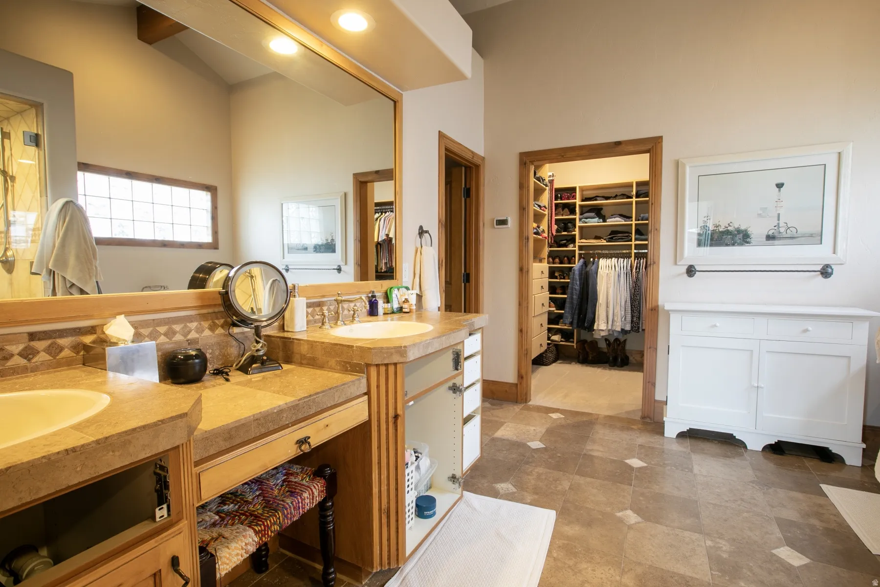 Dual vanity with integrated sinks, ample countertop space, and a built-in makeup area