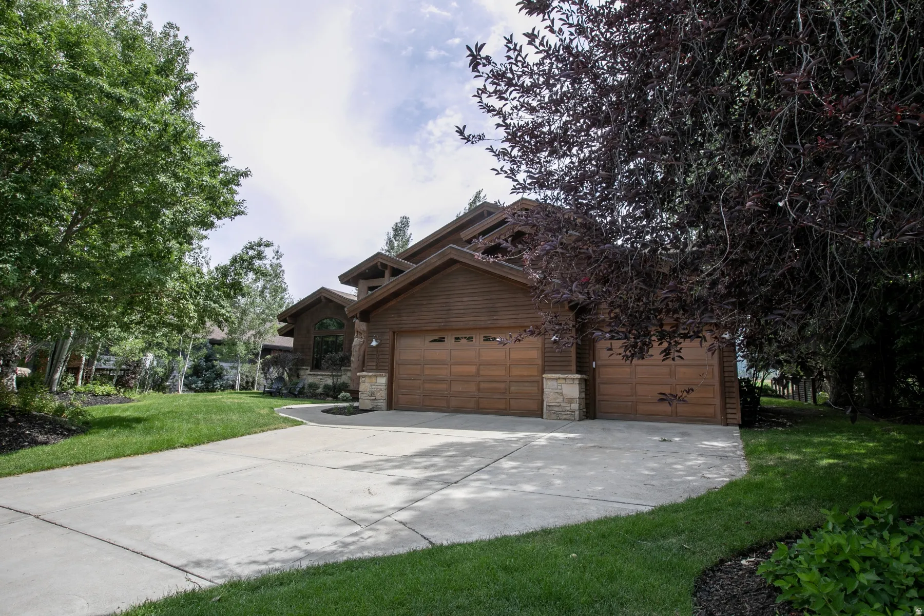Wood-sided exterior featuring stacked stone accents