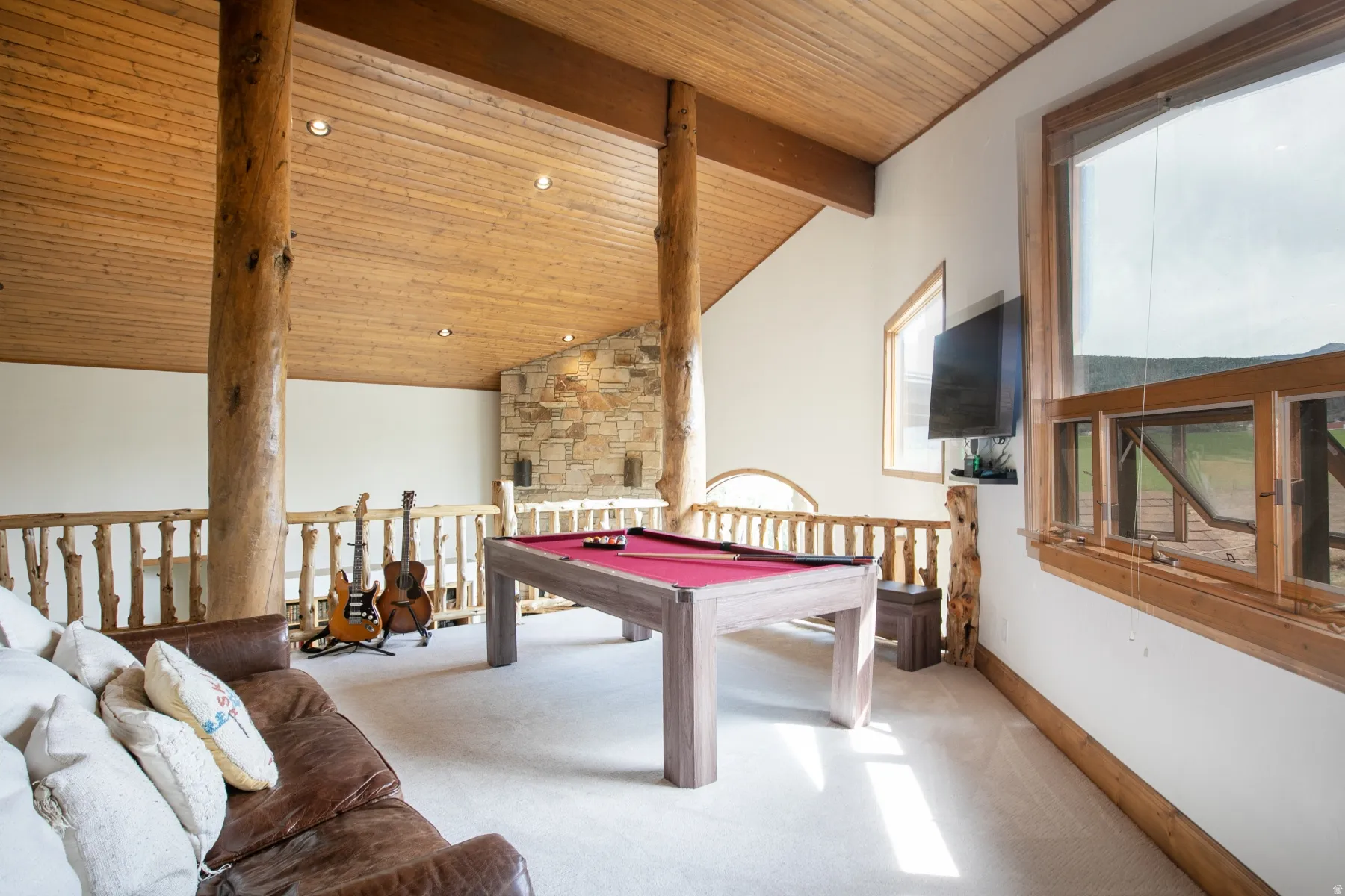 Vaulted wood-paneled ceiling with recessed lighting