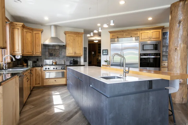 Contemporary kitchen featuring a large island with an integrated sink and breakfast bar