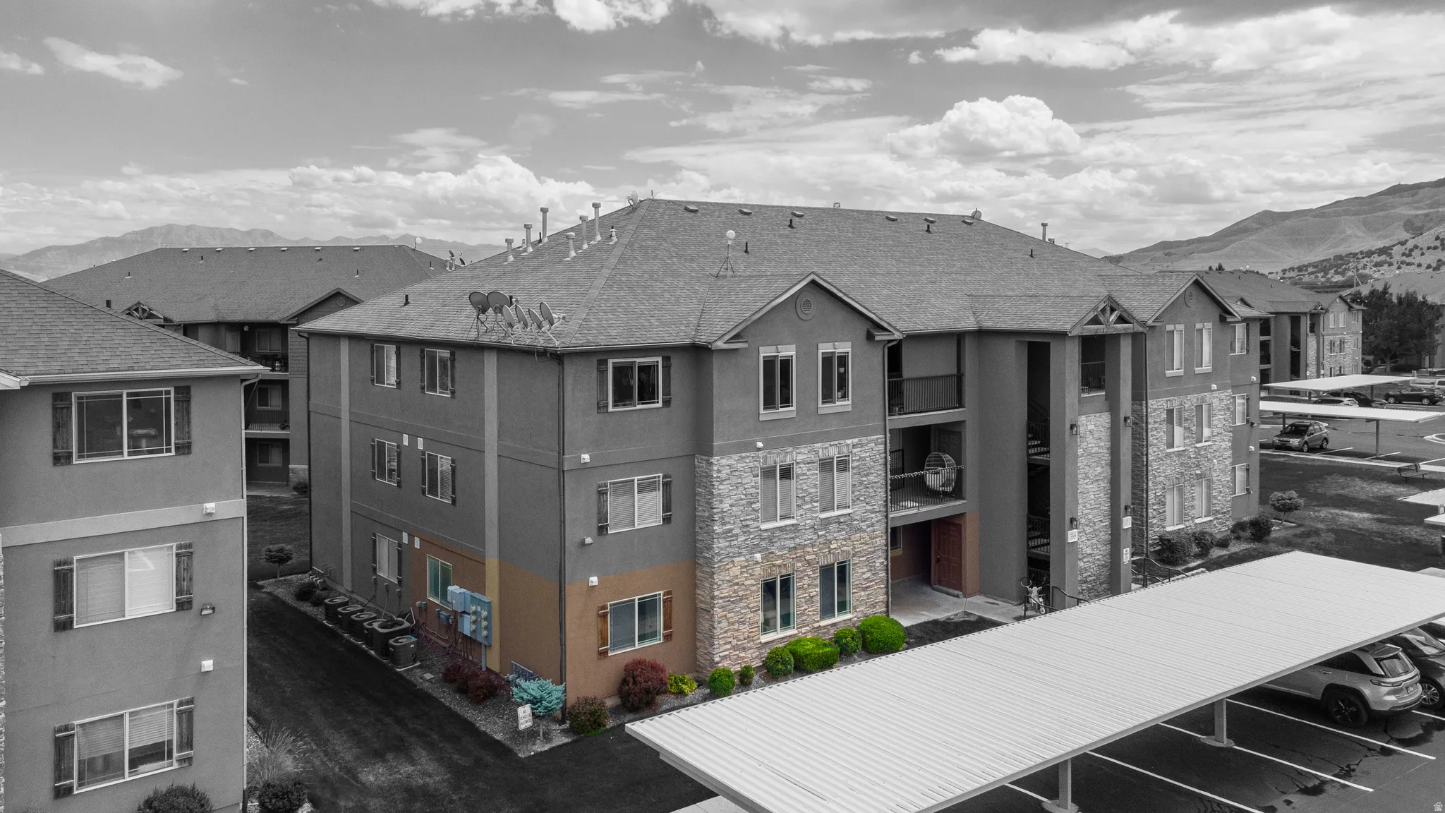 Multi-story building featuring a stucco and stone veneer exterior