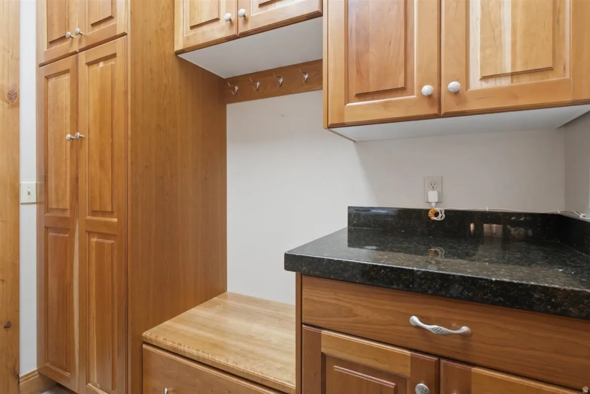 Custom cabinetry with a built-in bench and storage drawers, featuring a dark speckled countertop
