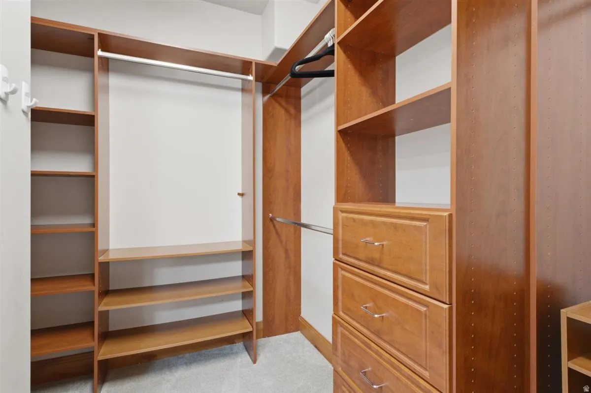 Custom closet system featuring built-in shelving, hanging rods, and integrated drawers with polished hardware