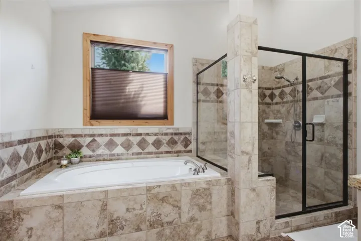 Built-in soaking tub with a tiled surround, featuring a diamond pattern accent border