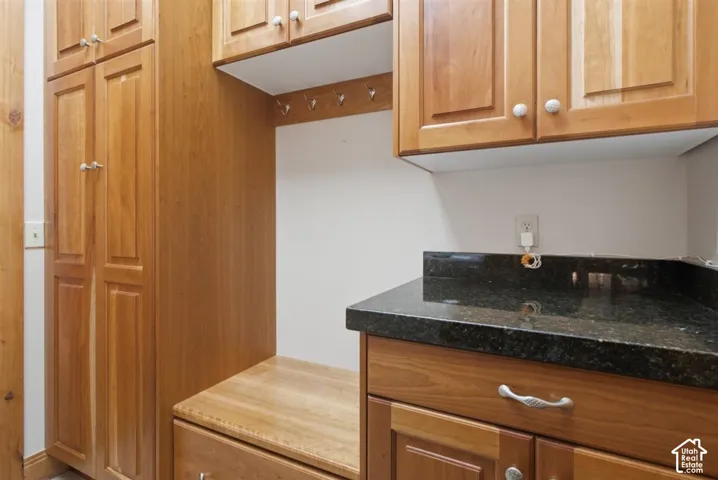 Custom cabinetry with a built-in bench and storage drawers, featuring a dark speckled countertop