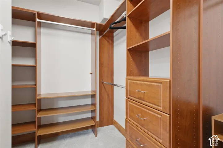 Custom closet system featuring built-in shelving, hanging rods, and integrated drawers with polished hardware