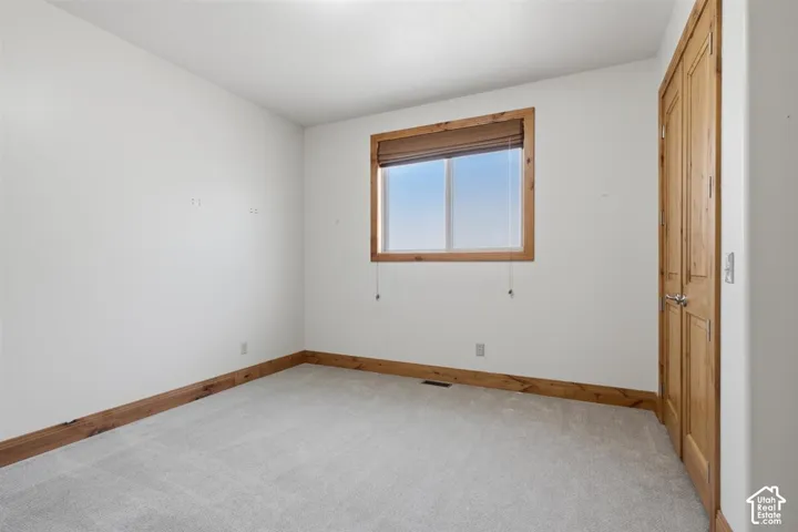 Light colored carpet paired with white walls