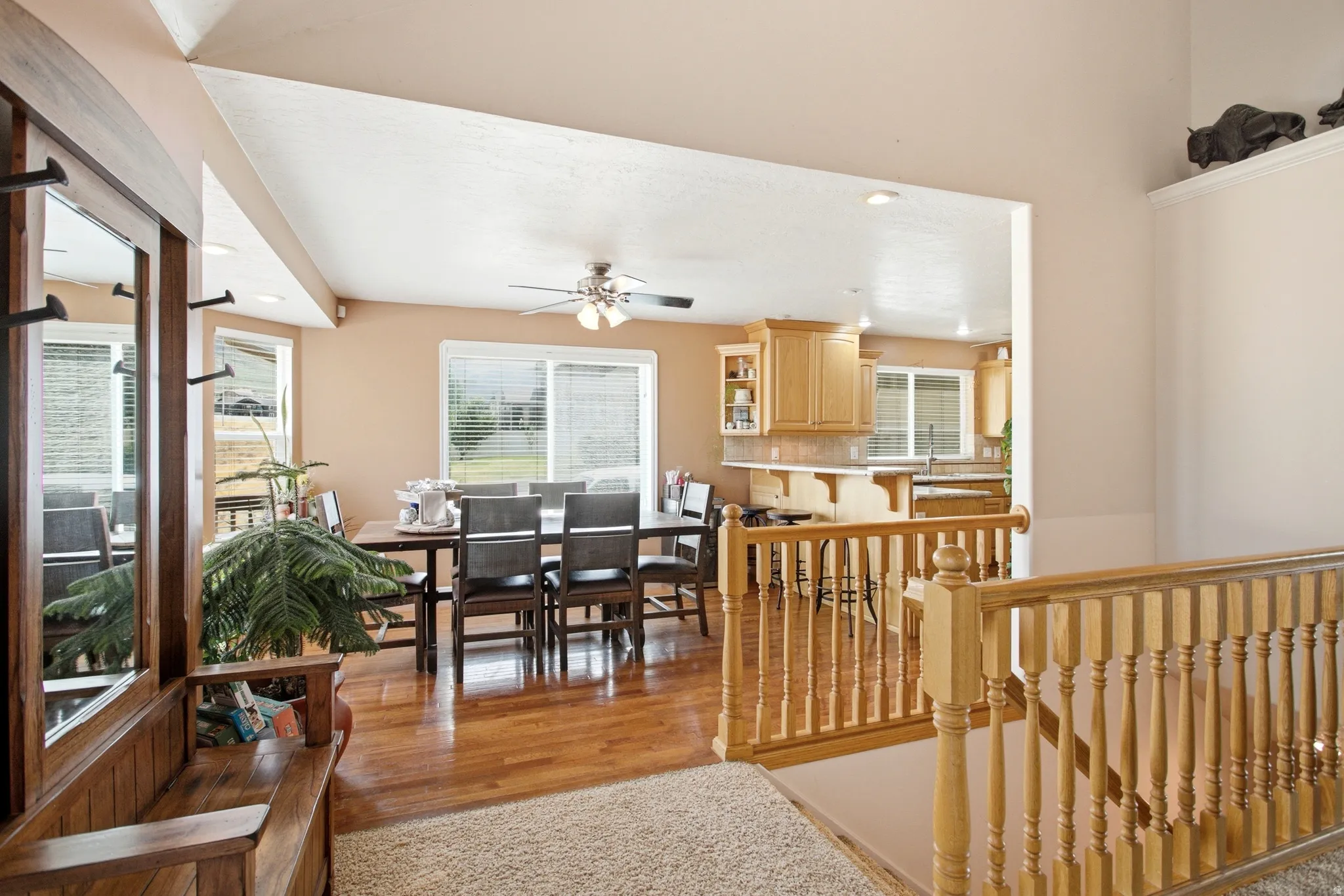 Open-concept living space with wood-finish flooring extending into the dining area