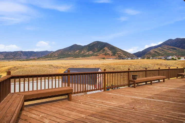 Expansive wood-finish deck with integrated seating and protective railing