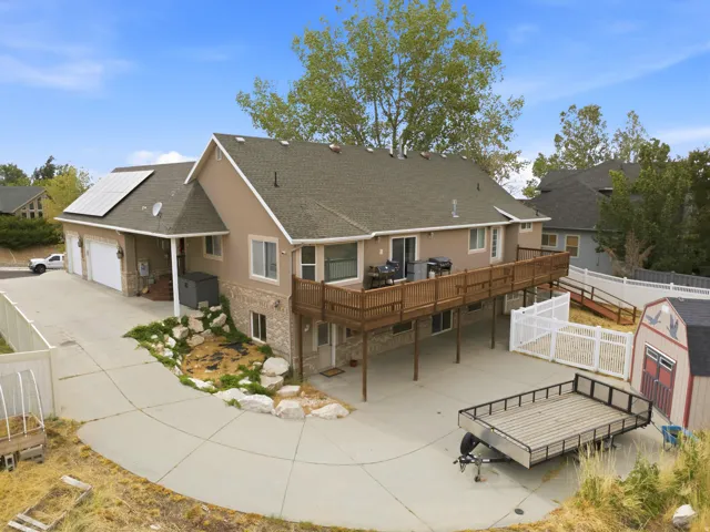 Stucco and stone facade property with an expansive wood-finish deck