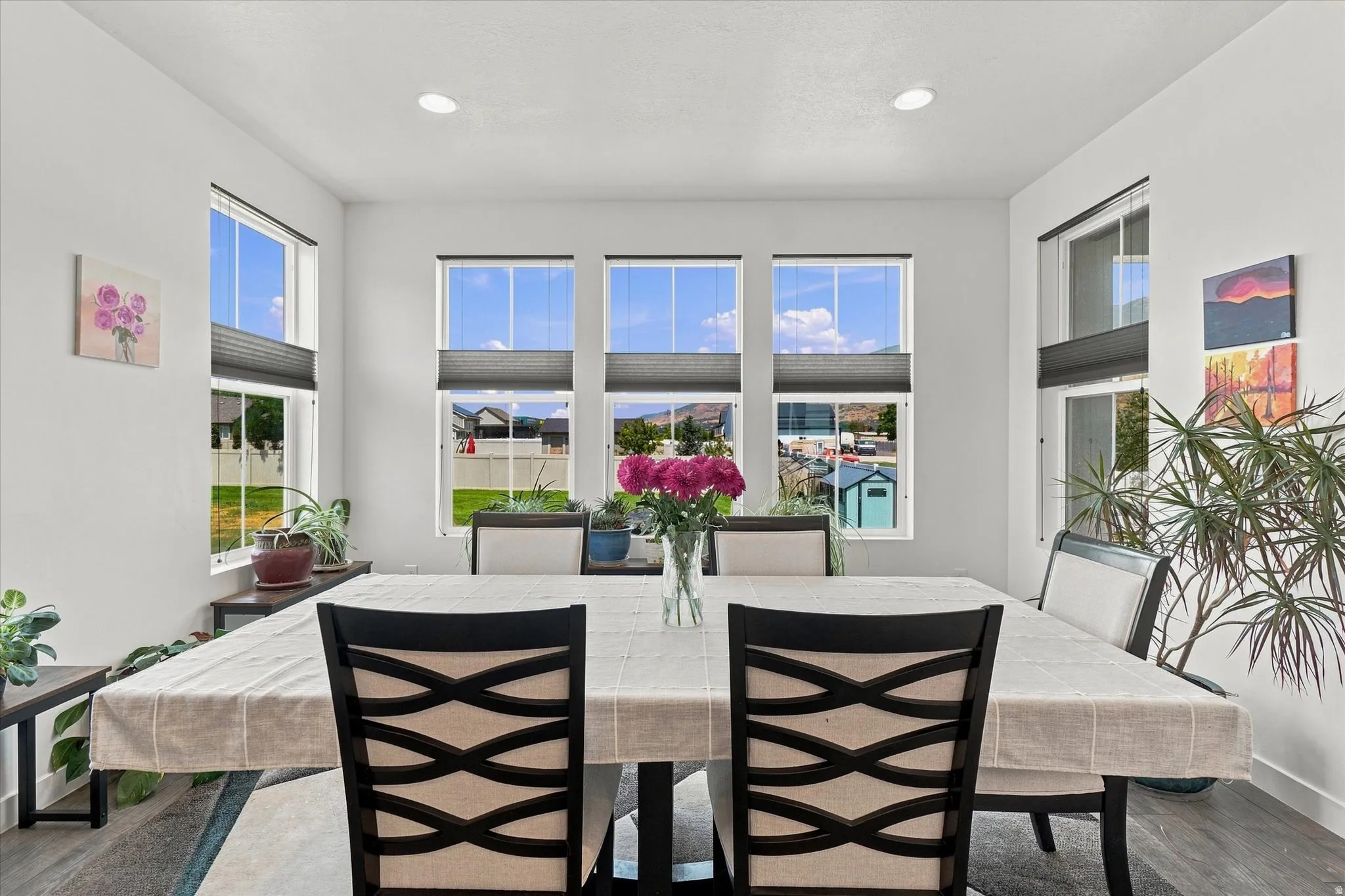 Dining area featuring high ceilings, recessed lighting, and wood-finish flooring