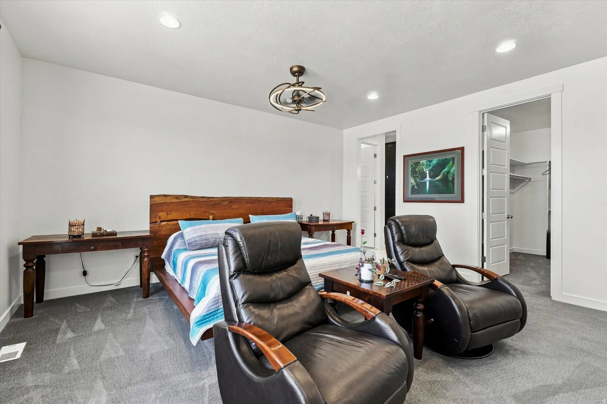 Spacious room featuring vaulted ceilings, recessed lighting, and soft gray carpeting