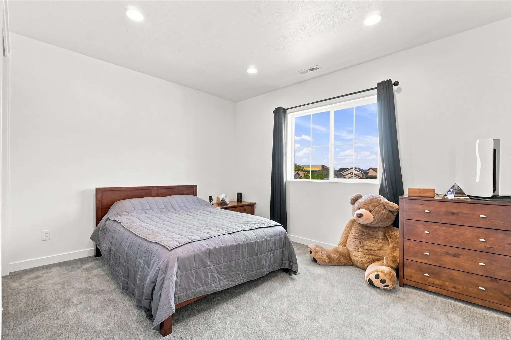 Bedroom featuring a large window, recessed lighting, white walls, and gray carpet