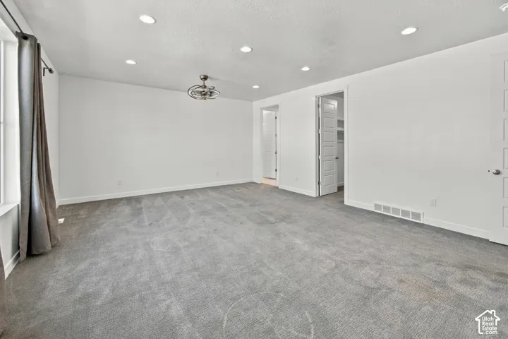Expansive primary bedroom room featuring recessed lighting, a ceiling fan, and gray carpeting