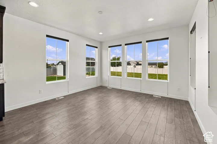 Abundance of windows, flooring, recessed ceiling lighting could make a 4th bedroom