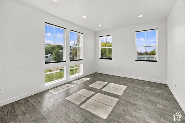 Engineered wood flooring, recessed lighting, and multiple windows. Top down shades.
