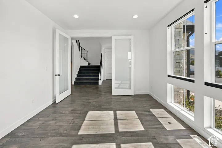Engineered wood flooring, top down shades, recessed lighting, and large windows. Could become a bedroom.