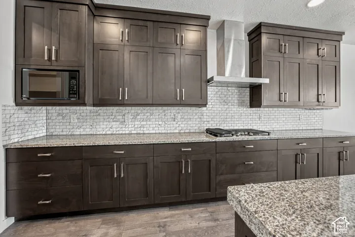 Abundance of Dark wood-finish cabinetry with brushed nickel hardware