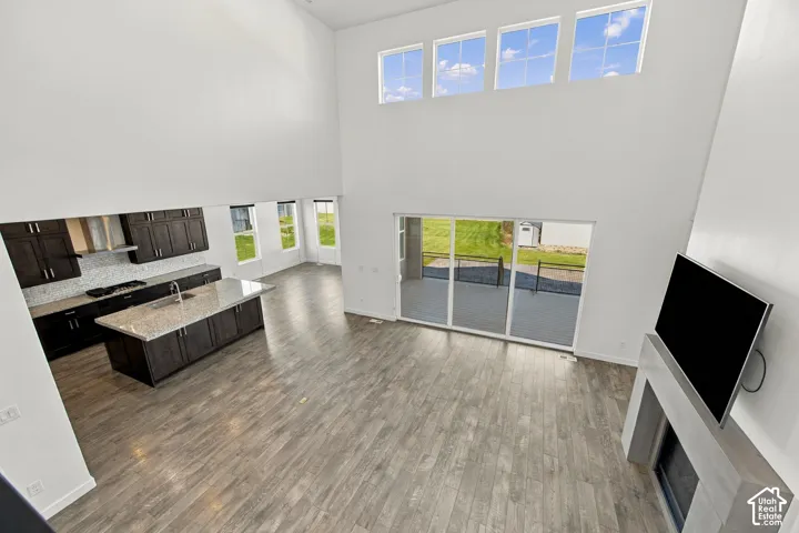 Vaulted ceilings with high windows, engineered wood flooring
