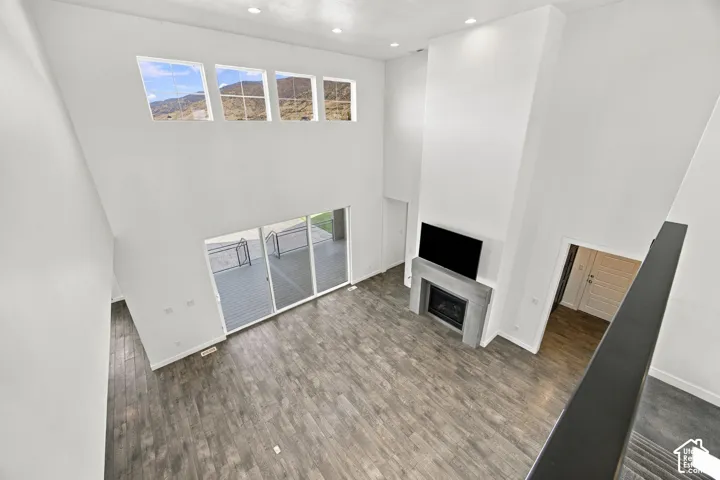 High ceilings with multiple upper windows create an uncommon open feeling lookin over sliding glass doors leading to an outdoor 4 season covered deck