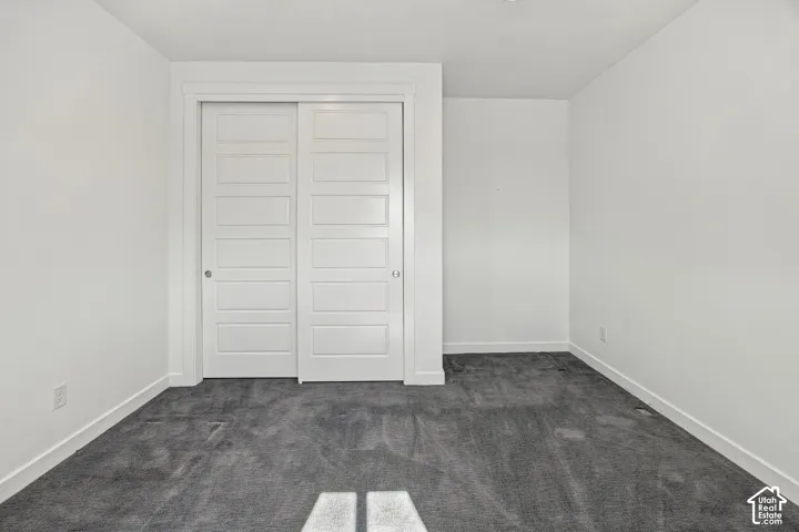 Recessed sliding closet doors with paneled detailing, shelving and rods for convenience of storage