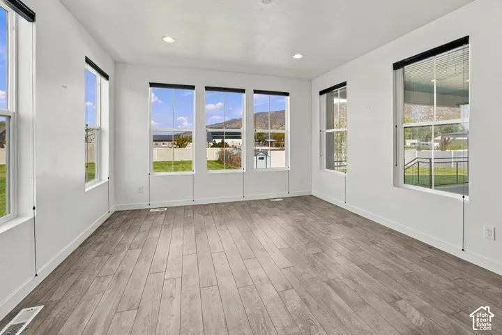 Enginnered Wood flooring, recessed lighting, abundance of windows with top down shades, views of yard