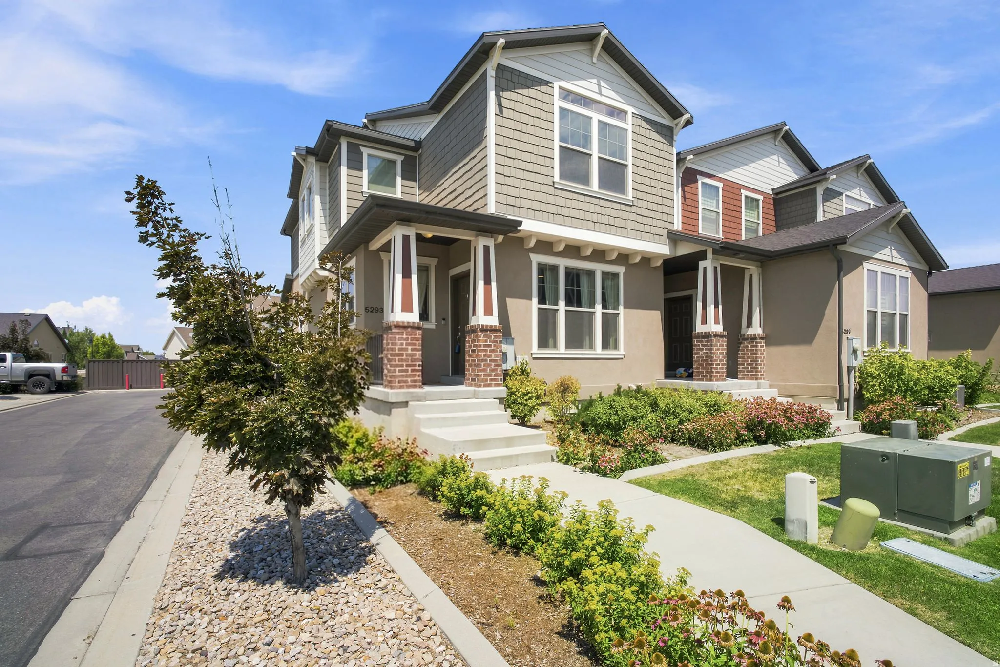 Multi-story property featuring a prominent portico entry with brick columns