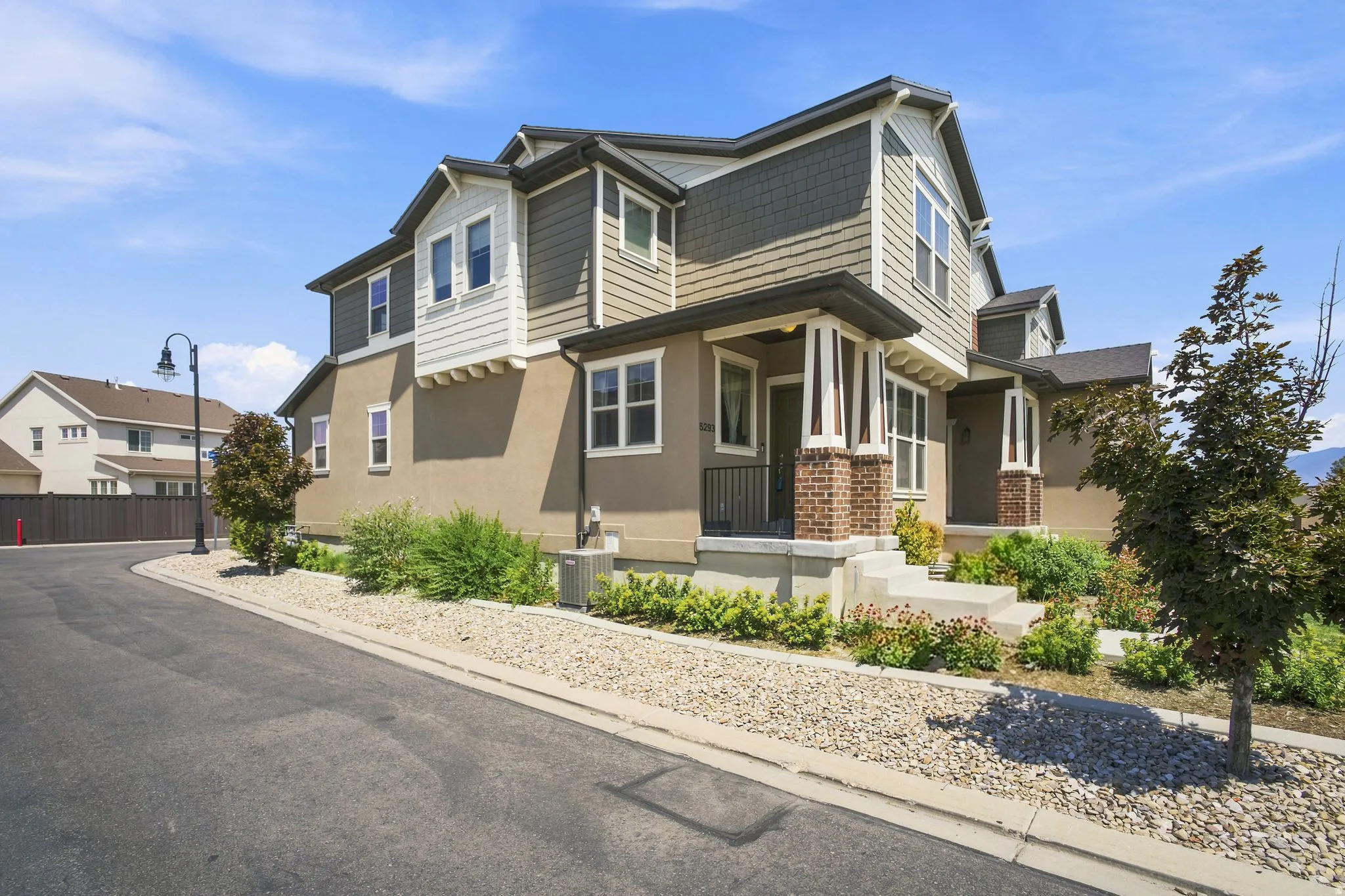Two-story residence featuring stucco and horizontal siding with shingle accents