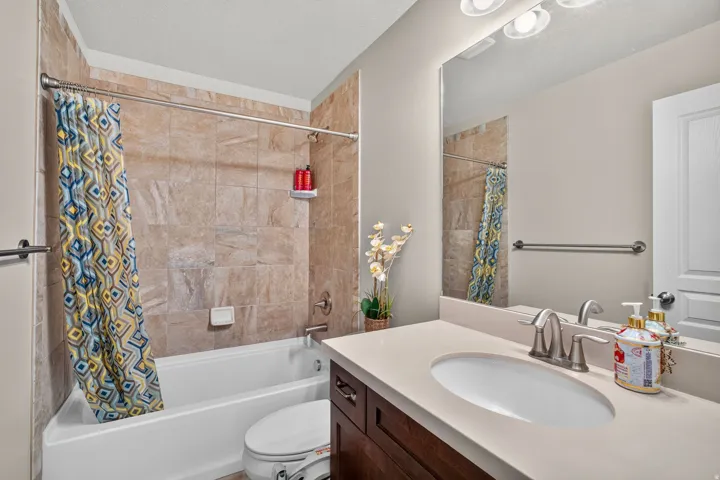Bathroom featuring a tile-surround tub and shower combination