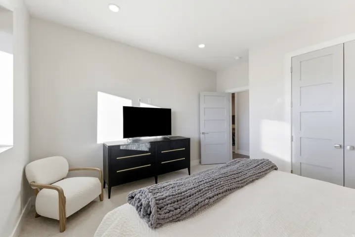 Room featuring light-colored walls and recessed ceiling lighting