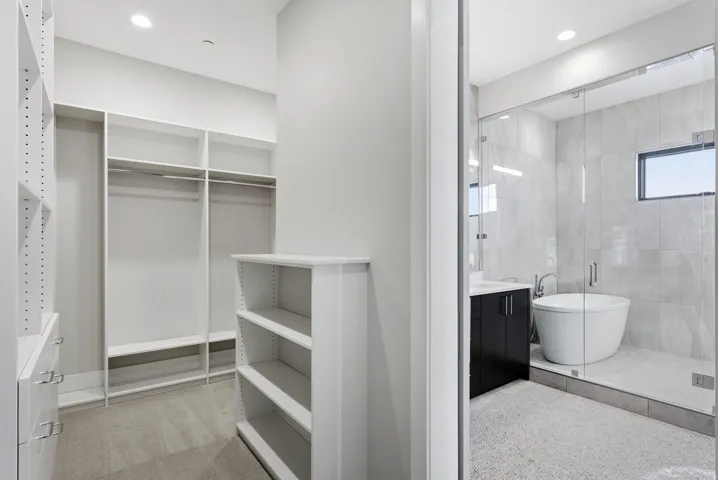 Custom closet system with built-in shelving and hanging rods