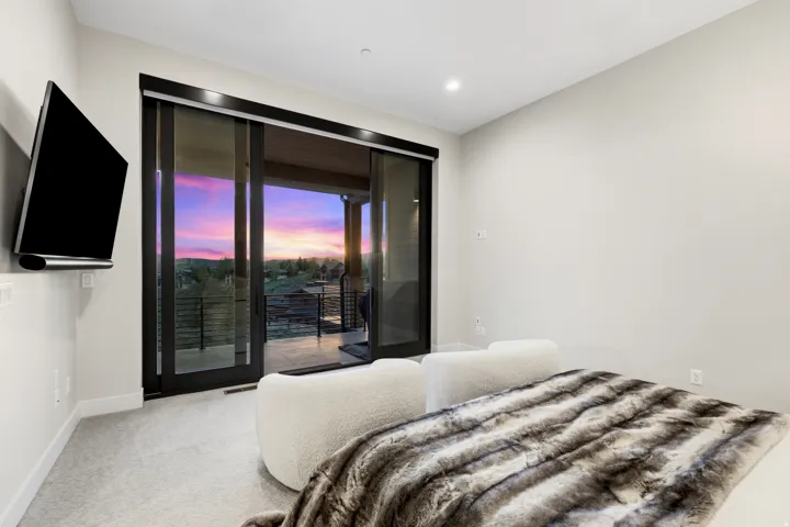 Expansive sliding glass doors open to a private balcony