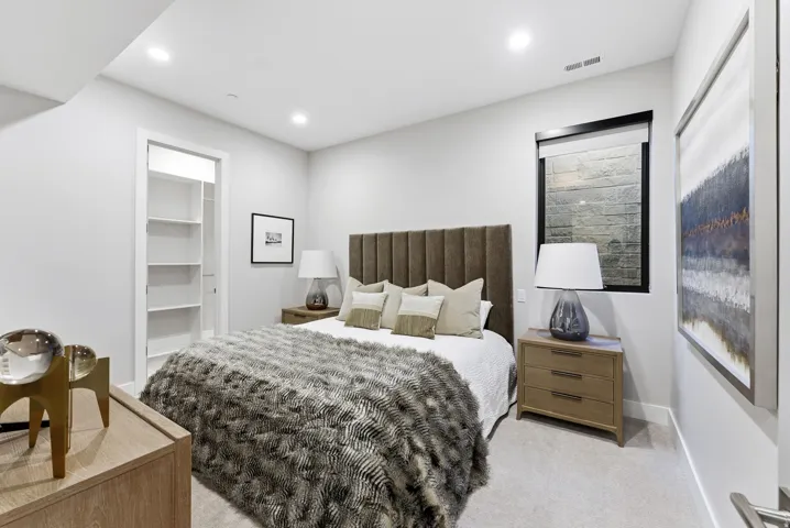 Bedroom featuring recessed lighting, a built-in closet with shelving, and light-colored carpet flooring