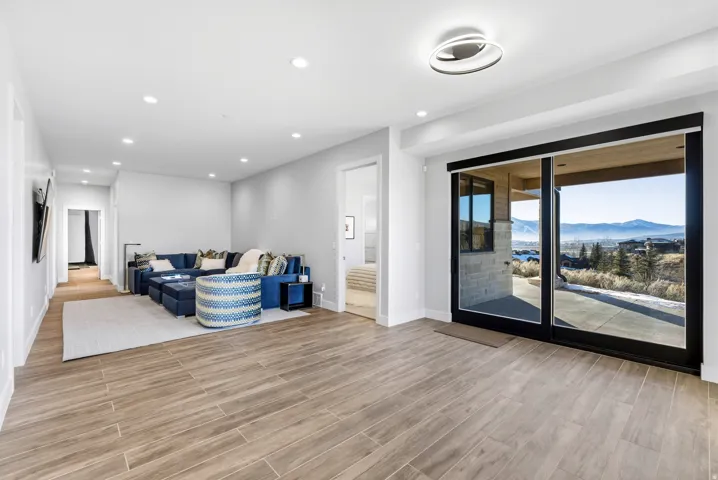 Spacious interior featuring wood-finish flooring, recessed lighting, and a contemporary ceiling fixture